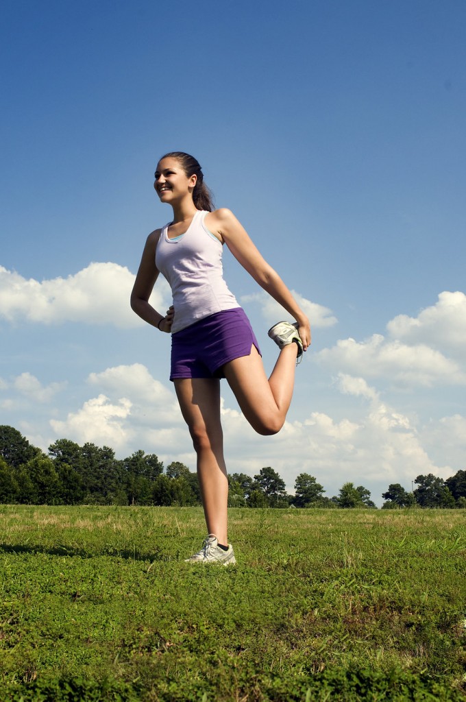 15251-a-young-woman-stretching-outdoors-before-exercising-pv